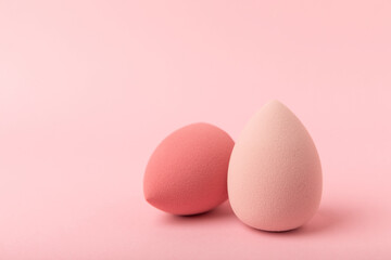Beauty blender. Cosmetic sponge on a pink background. MOCAP. Sponge for applying foundation and concealer. Beauty concept. Space for text. Space for copy space.