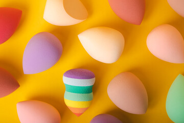 Beauty blender. Cosmetic sponge on a yellow background. MOCAP. Sponge for applying foundation and concealer. Beauty concept. Space for text. Space for copy space.