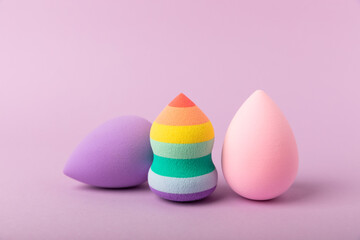 Beauty blender. Cosmetic sponge on a lilac background. MOCAP. Sponge for applying foundation and concealer. Beauty concept. Space for text. Space for copy space.