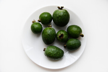 Green feijoa fruits close-up on a white background. Beautiful feijoa fruits.