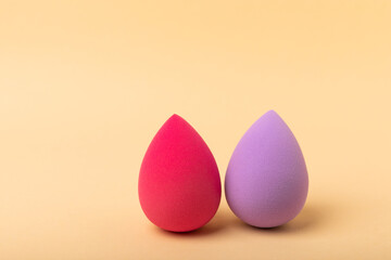 Beauty blender. Cosmetic sponge on a beige background. MOCAP. Sponge for applying foundation and concealer. Beauty concept. Space for text. Space for copy space.