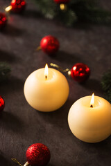 Two large round candles with Christmas decoration