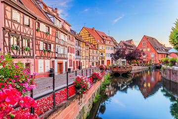 Colmar, Alsace. France. Petite Venice, water canal and traditional half timbered houses. - obrazy, fototapety, plakaty