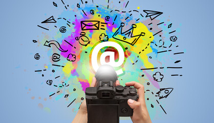 Close-up of a hand holding digital camera with abstract drawing concept