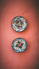 Colorful plates on a red wall