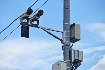 Road speedcam radar control speed limit unit on a mast on blue sky background