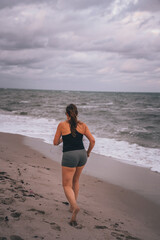 Fototapeta na wymiar woman running on the beach sport life miami 