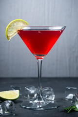 Alcoholic drink, Maritini cocktail with berry juice and lime in a glass.