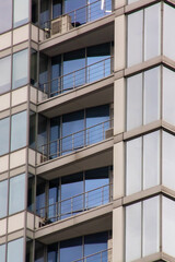Balconies on a glass tall building closeup
