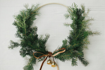 Merry Christmas and Happy Holidays! Modern christmas wreath flat lay. Stylish christmas wreath with...