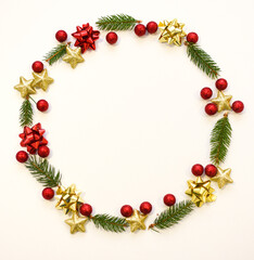 Christmas tree branches, red balls and stars, New Year's decor on a white background. Christmas frame for your text
