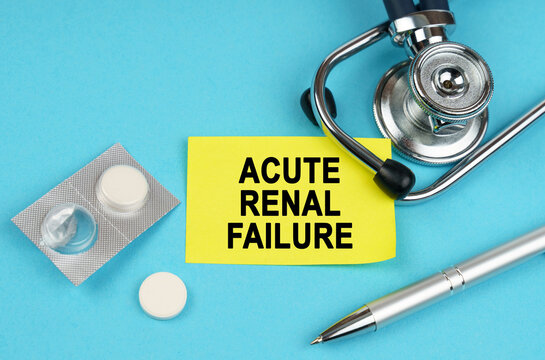 On a blue surface, a stethoscope, pills, a pen and a yellow sticker with the inscription - Acute renal failure