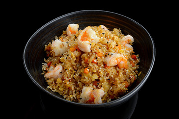 Fried rice with shrimp and sesame, on a dark background