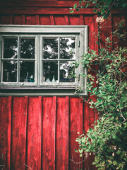 Window in a red, wooden Swedish summer house