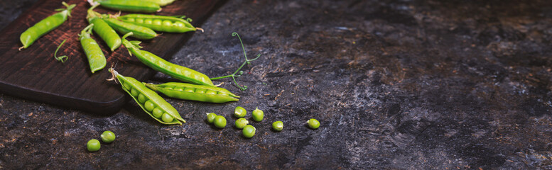Rural still life, banner horizontal - view of the pea crop, selective focus, close-up on a dark background with space for text. The harvest concept