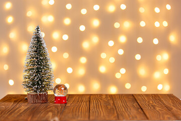 christmas tree, clock, sledge, snowman, candles, gifts on a wooden background and lights background