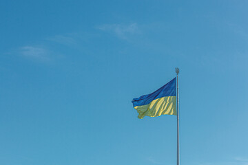 Ukrainian flag against the blue sky