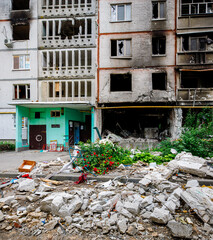 Destroyed facade of a residential high-rise building as a result of a Russian air bomb hit. War in...