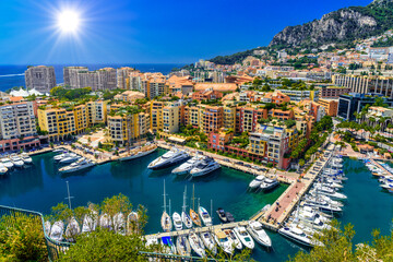 Fototapeta na wymiar Yachts in bay near houses and hotels, Fontvielle, Monte-Carlo, Monaco, Cote d'Azur, French Riviera
