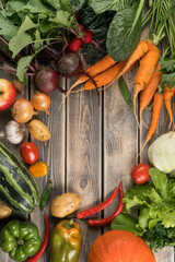 Vertical colorful tasty food composition of variety, assortment of healthy organic garden vegetables on wooden background. Grocery, food market and store. Health care. Copy space, top view, flat lay
