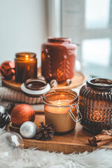 Burning candle on windowsill in cozy home interior