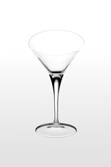 Glass of martini levitating on white background