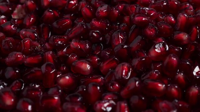 Macro photography of bright red pomegranate fruit seeds. Rotating red ripe pomegranate. High quality 4k footage
