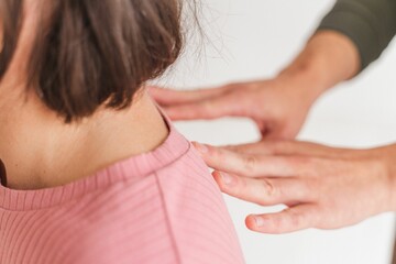 Close-up shot of female hands giving shoulder massage to a pregnant woman - Hypnobirthing concept