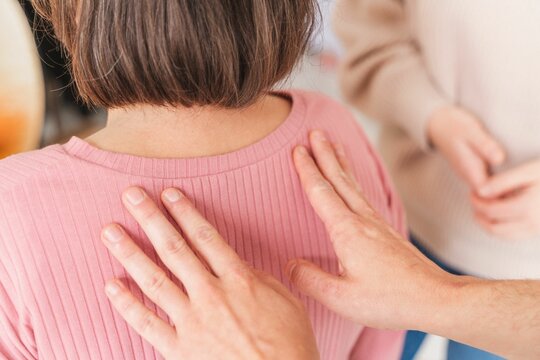Close-up shot of female hands giving shoulder massage to a pregnant woman - Hypnobirthing concept