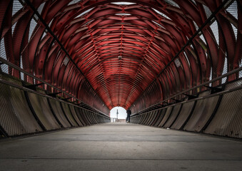 red metal footbridge, photo taken at ground level