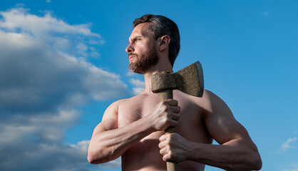 shirtless confident man with axe. caucasian man hold ax. brutal man on sky background