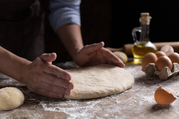 Chef man kneading dough bread or pizza for homemade cooking at table