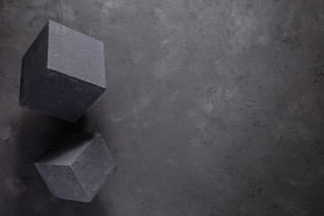Cement block on floor background as construction concept. Concrete cube with abstract art idea