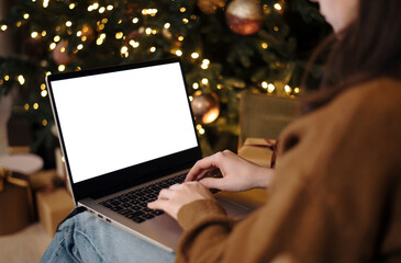 woman work on laptop computer with blank display screen with mockup copy space. Concept of online shopping, discounts or online communication at a distance