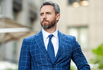 Fototapeta premium portrait of boss in jacket. caucasian boss standing outside. professional boss in formalwear