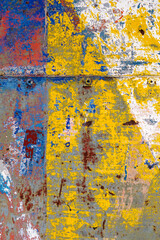 Colorful chaotic paint brush strokes on a rough old wall