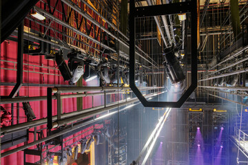 Technical equipment at the backstage of theater. Stage spot lighting rigging structure for a live...
