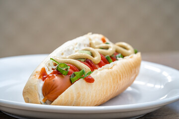 hot dog with mustard ketchup and spring onion