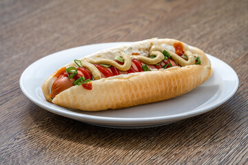 hot dog with mustard ketchup and spring onion