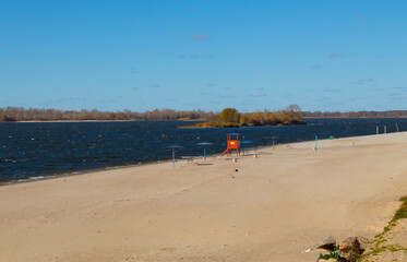 Empty sandy beach on the banks of the Dnieper river on a sunny autumn day. Kremenchuk City, Ukraine