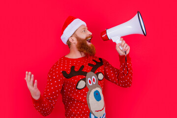 merry xmas. happy man announcing in loudspeaker about xmas sales. man at xmas isolated on red