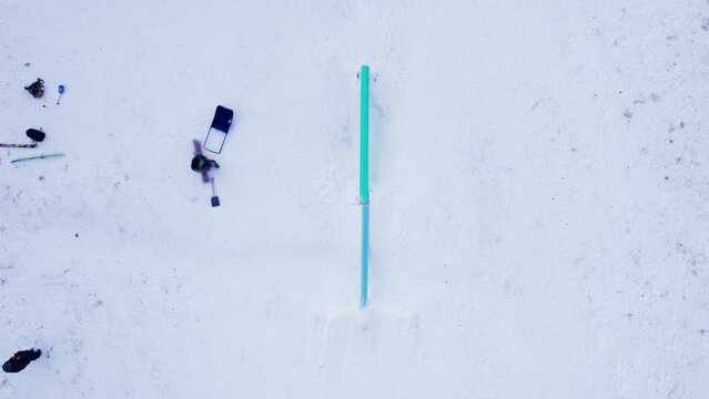 Overhead shot freestyle snowboarder terrain park rail slide, ski slope, trick skier, Whistler, winter sport. 4K 24FPS.