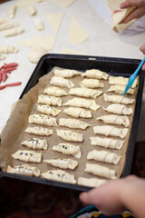 The process of making homemade croissants and other pastries at home. The family is cooking dessert together in the kitchen.