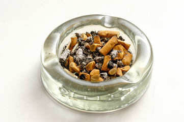 Ashtray seen from above full of cigarette butts.