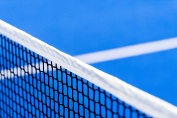 Paddle tennis and tennis net on blue court. Tennis competion concept. Horizontal sport poster,...