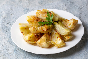 Organic Baked Fennel Bulbs with Salt and Pepper. Fennel dish with olive oil.
