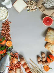 Allergy food concept. allergene - milk, fish, strawberry, bread, eggs, peanuts, citrus, wheat flower and others on grey backgrond