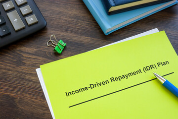 Income driven repayment IDR plan near calculator and notepads.
