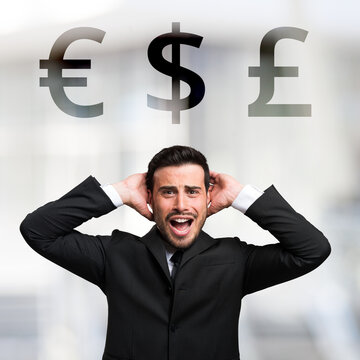 Desperate businessman in front of Euro, Dollar and Pound