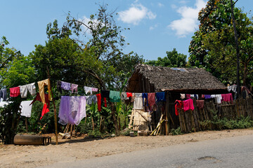 Drying of the washed colorful clothes on the hot african sun, typical scene from the African...